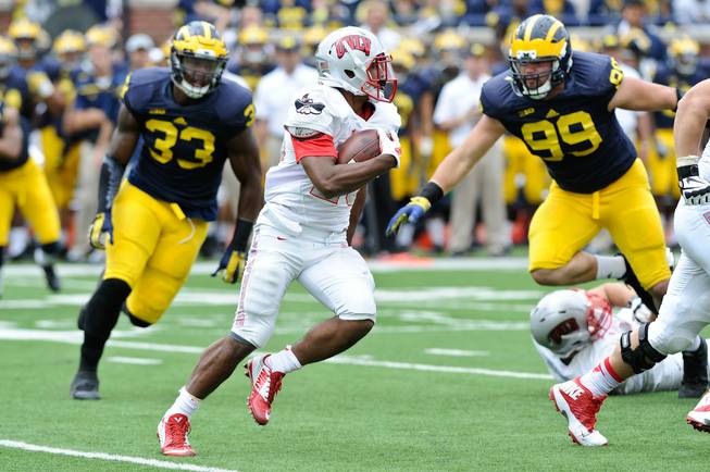 UNLV RB Keith Whitely, 28, looks for running room during their game at Michigan Stadium on Saturday, September 19, 2015.