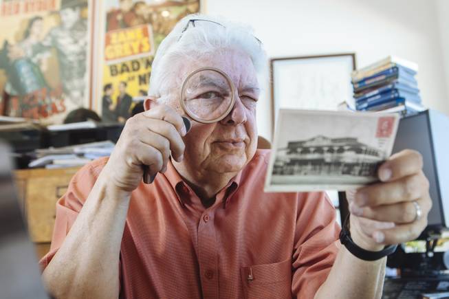 Bob Stoldal examines a postcard in his office on September 19, 2015.