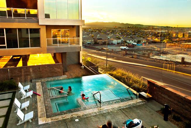 Sunset falls on one of several pools Wednesday, March 25, 2015, at Vantage Lofts, an upscale apartment complex in Henderson that was mothballed during the recession. An investor completed the complex after buying it in 2013.