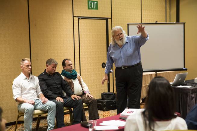 Doc Stevens, from Detroit Michigan, conducts a hypnosis session during a stage hypnosis training seminar at The Orleans, Tuesday Aug. 25, 2015.