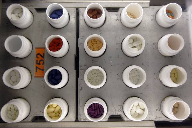 In this June 14, 2011, file photo, various prescription drugs move along the automated pharmacy assembly line at Medco Health Solutions in Willingboro, N.J.