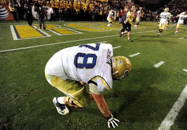 Georgia Tech offensive lineman Trey Braun (78) falls to the ground after his team fails to convert against Georgia during the second overtime of an NCAA football game on Saturday, Nov. 30, 2013, in Atlanta. Georgia won 41-34 in double overtime.