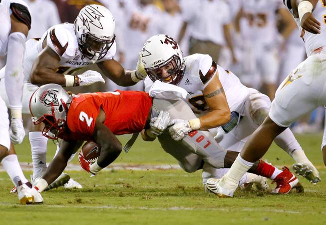 New Mexico wide receiver Dameon Gamblin (2) is hit by Arizona State defensive back Jordan Simone (38) during the first half of an NCAA college football game, Friday, Sept. 18, 2015, in Tempe, Ariz. (AP Photo/Matt York)