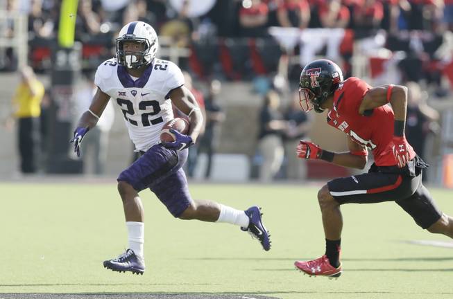 TCU running back Aaron Green (22) finds open field to run against Texas Tech defensive back Justis Nelson (31).