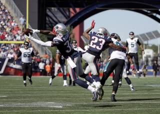 New England Patriots safety Devin McCourty (32) intercepts a pass thrown by Jacksonville Jaguars quarterback Blake Bortles (5) and intended for Jaguars tight end Marcedes Lewis (89) in the first half of an NFL football game, Sunday, Sept. 27, 2015, in Foxborough, Mass. (AP Photo/Steven Senne)