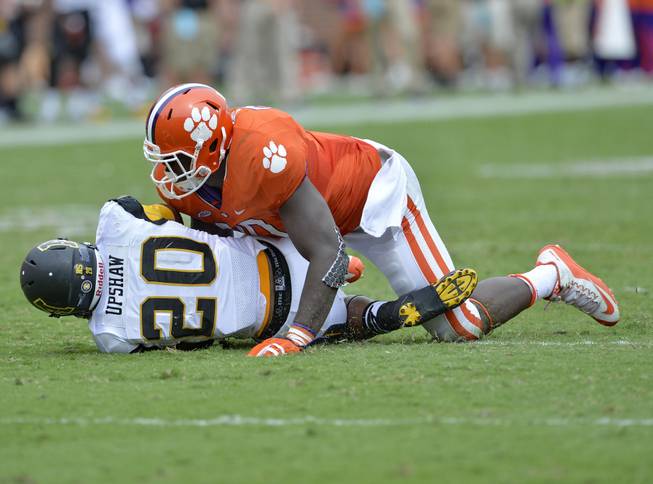 Clemson's Shaq Lawson, top, tackles Appalachian State's Terrence Upshaw during the second half of an NCAA college football game Saturday, Sept. 12, 2015, in Clemson, S.C. Clemson won 41-10.
