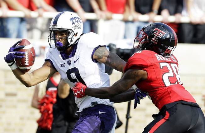 TCU wide receiver Josh Doctson (9) catches a touchdown pass against Texas Tech defensive back Paul Banks (28) during the first half of an NCAA college football game Saturday, Sept. 26, 2015, in Lubbock, Texas.