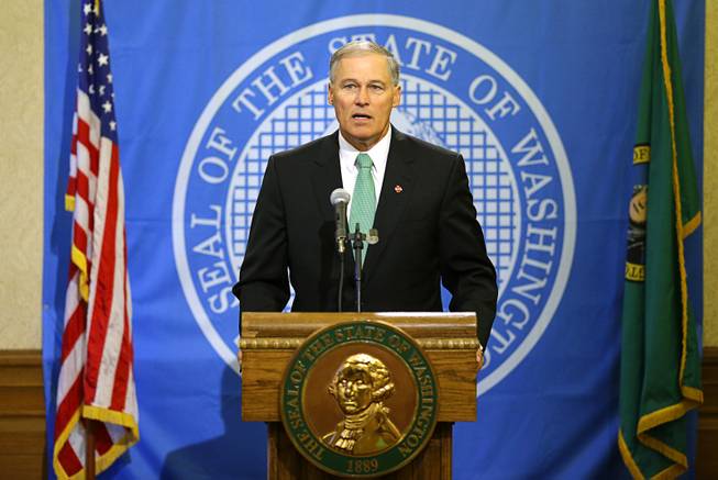 During a media briefing Thursday, Oct. 1, 2015, in Olympia, Wash., Washington Gov. Jay Inslee expresses his sympathy and concern for those affected by the shooting at Umpqua Community College in Roseburg, Ore. (AP Photo/Ted S. Warren)