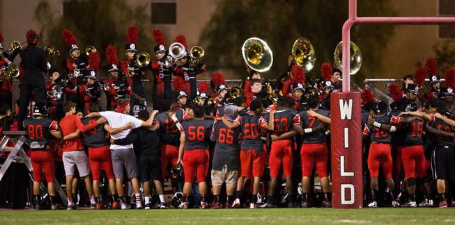 Las Vegas High School players come together for the school song with their band after dominating Coronado 43-0 during their football game on Friday, December 02, 2015.