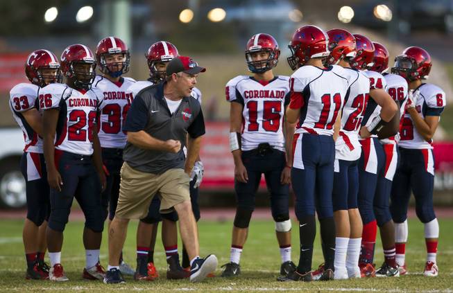 Coronado High School head coach William Froman gets pumped up with his players before facing Las Vegas, Friday, Oct. 2, 2015.