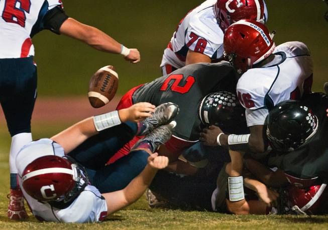 Las Vegas High School's Cruz Littlefield, 2, causes Coronado's Conall McIntyre, 46, to fumble from a hard tackle during their football game on Friday, December 02, 2015.
