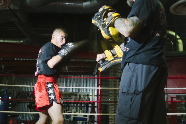 Jonathon "Cisco" Cosio, a muay thai fighter, practices with his coach  at the Sport Center of Las Vegas on September 24, 2015.
