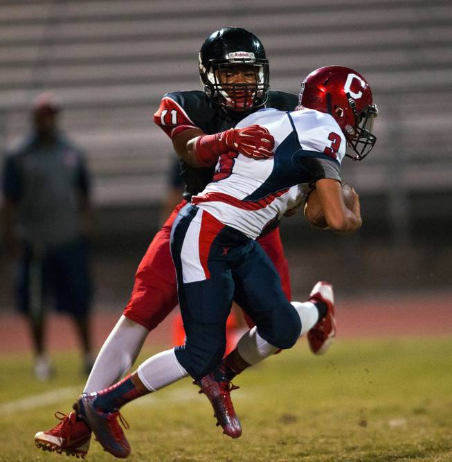Las Vegas High School's Archie McArthur,11, gets a sack on Coronado QB ,3, during their football game on Friday, December 02, 2015.