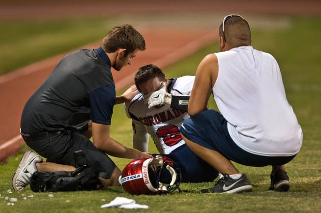 Coronado High School's Darius Cambe, 9, is consoled while crying on the sidelines after a lopsided loss to Las Vegas in their football game on Friday, December 02, 2015.