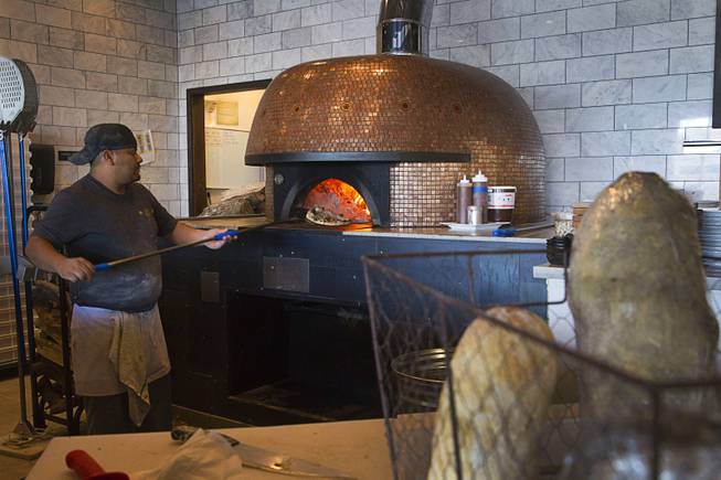 A chef turns a pizzette at the Settebello Pizzeria Napoletana, 9350 W. Sahara Ave., Oct. 4, 2015. Happy Hour is from 3 p.m. to 6 p.m., Monday through Friday and from 8 p.m. to 9 p.m., Monday through Thursday. On Friday, Happy Hour resumes at 8:30 p.m. and runs until 10 pm.