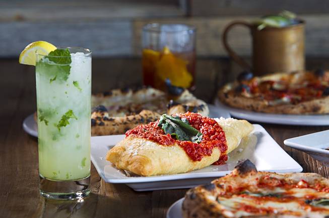 A Fritta is shown among cocktails and pizzettes at the Settebello Pizzeria Napoletana, 9350 W. Sahara Ave., Oct. 4, 2015. The drinks include a Mint Collins, left, an Old Fashioned, center, and a Moscow Mule, back right. Happy Hour is from 3 p.m. to 6 p.m., Monday through Friday and from 8 p.m. to 9 p.m., Monday through Thursday. On Friday, Happy Hour resumes at 8:30 p.m. and runs until 10 pm.