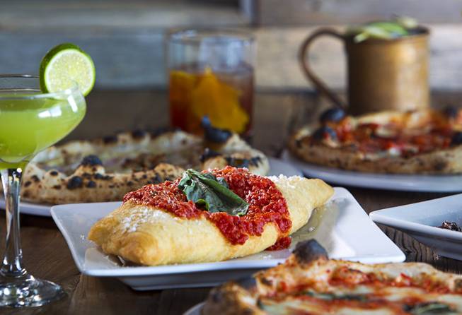 A Fritta is shown among cocktails and pizzettes at the Settebello Pizzeria Napoletana, 9350 W. Sahara Ave., Oct. 4, 2015. The drinks include a Basil Gimlet, left, Old Fashioned, back center, and a Moscow Mule. Happy Hour is from 3 p.m. to 6 p.m., Monday through Friday and from 8 p.m. to 9 p.m., Monday through Thursday. On Friday, Happy Hour resumes at 8:30 p.m. and runs until 10 pm.
