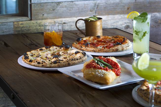 A Fritta, center, is shown among cocktails and pizzettes at the Settebello Pizzeria Napoletana, 9350 W. Sahara Ave., Oct. 4, 2015. The drinks from left: Old Fashioned, a Moscow Mule, a Mint Collins and a Basil Gimlet. Happy Hour is from 3 p.m. to 6 p.m., Monday through Friday and from 8 p.m. to 9 p.m., Monday through Thursday. On Friday, Happy Hour resumes at 8:30 p.m. and runs until 10 pm.