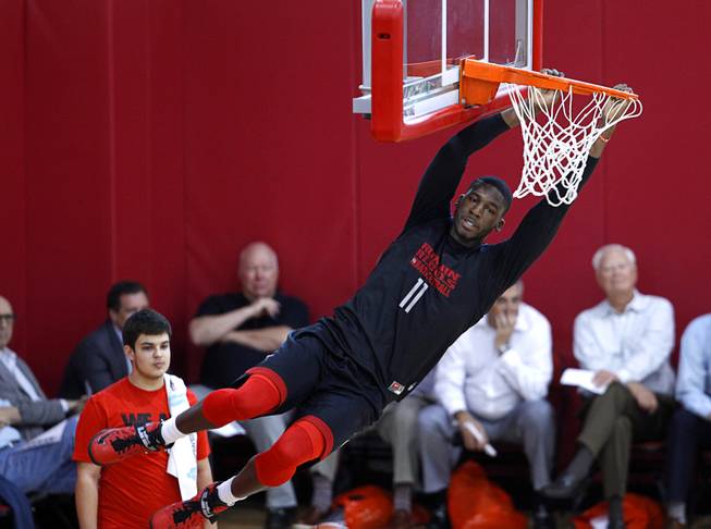 Goodluck Okonoboh (11) hangs on the rim during the Rebels' first basketball practice of the season at the Mendenhall Center on UNLV campus Monday, Oct. 5, 2015.