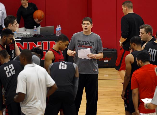 Head Coach Dave Rice, center, talks with players during the Rebels' first basketball practice of the season at the Mendenhall Center on UNLV campus Monday, Oct. 5, 2015.