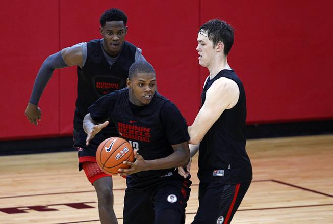Tyrell Green, center, (12) looks to pass during the Rebels' first basketball practice of the season at the Mendenhall Center on UNLV campus Monday, Oct. 5, 2015.