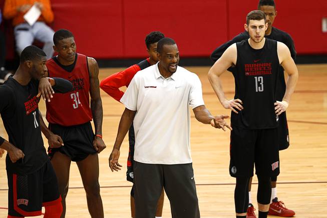 Stacey Augmon, center, associate head coach, talks with players during the Rebels' first basketball practice of the season at the Mendenhall Center on UNLV campus Monday, Oct. 5, 2015.