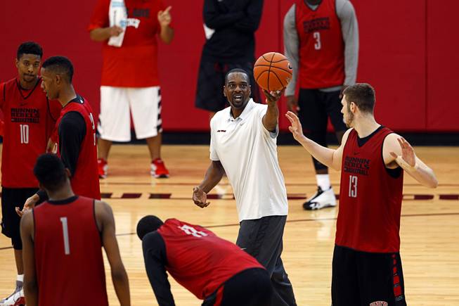 Stacey Augmon, center, associate head coach, runs drills with players during the Rebels' first basketball practice of the season at the Mendenhall Center on UNLV campus Monday, Oct. 5, 2015.