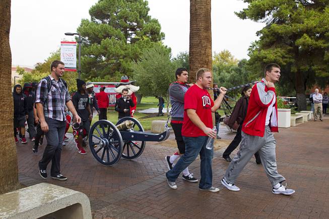 UNLV football players pull the Fremont Cannon to the student union for a cannon-painting ceremony Monday, Oct. 5, 2015, at UNLV. The Rebels recovered the Fremont Cannon after defeating the Wolfpack 23-17 on Saturday in Reno.