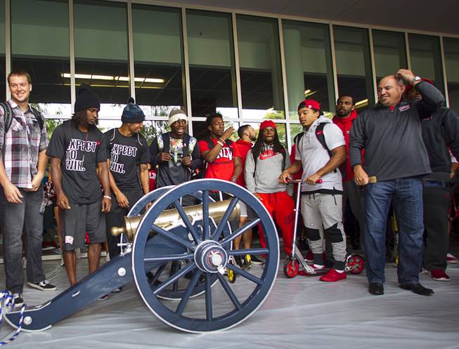 UNLV football coach Tony Sanchez, right, looks over the Fremont Cannon during a cannon-painting ceremony Monday, Oct. 5, 2015, at UNLV. The Rebels recovered the Fremont Cannon after defeating the Wolfpack 23-17 on Saturday in Reno.