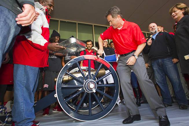 UNLV President Len Jessup paints the Fremont Cannon red during a ceremony Monday, Oct. 5, 2015, at UNLV. The Rebels recovered the Fremont Cannon after defeating the Wolfpack 23-17 on Saturday in Reno.
