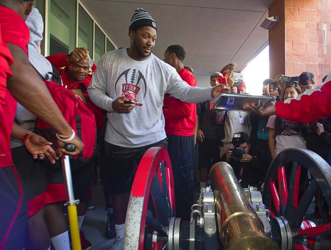 UNLV football players paint the Fremont Cannon red during a ceremony Monday, Oct. 5, 2015, at UNLV. The Rebels recovered the Fremont Cannon after defeating the Wolfpack 23-17 on Saturday in Reno.