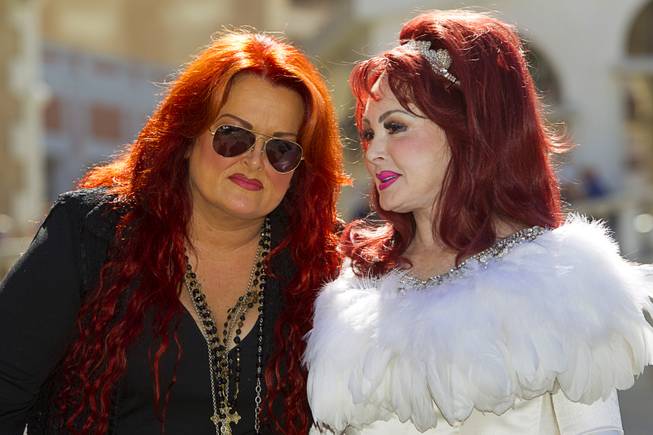 Wynonna listens to her mother, Naomi Judd, as they arrive Tuesday, Oct. 6, 2015, at the Venetian. Reuniting for the first time in nearly five years, the mother-daughter duo will perform at the Venetian Theater from Oct. 7-24, 2015.