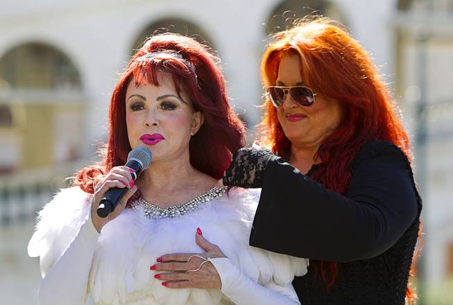 Wynonna arranges the hair of her mother, Naomi, Judd, as they arrive Tuesday, Oct. 6, 2015, at the Venetian. Reuniting for the first time in nearly five years, the mother-daughter duo will perform at the Venetian Theater from Oct. 7-24, 2015.