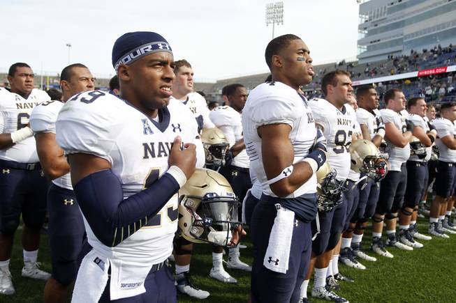 Navy quarterback Keenan Reynolds and his teammates after a win over Connecticut in an NCAA football game Saturday, Sept. 26, 2015, in East Hartford, Conn.