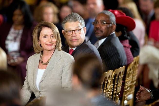 House Minority Leader Nancy Pelosi of Calif., left, Sen. Al Franken, D-Minn., and others wait for President Barack Obama to speak at the White House Summit on Worker Voice, Wednesday, Oct. 7, 2015, in the East Room of the White House in Washington. 