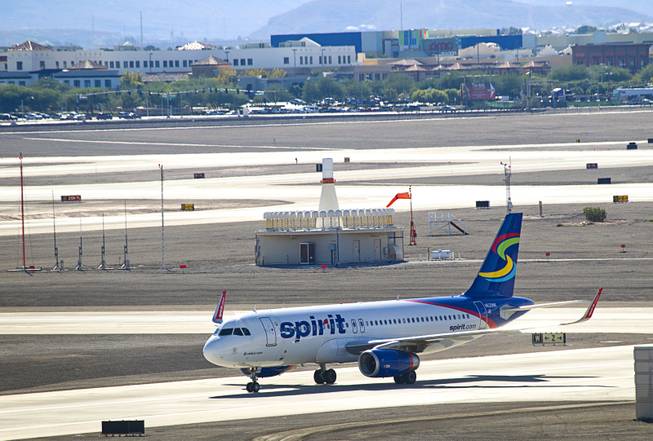 A Spirit passenger jet taxis to a gate after landing at McCarran International Airport Sunday, Oct. 11, 2015.