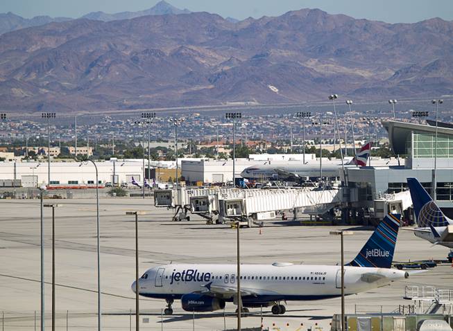 A JetBlue passenger jet taxis to a gate after landing at McCarran International Airport Sunday, Oct. 11, 2015.