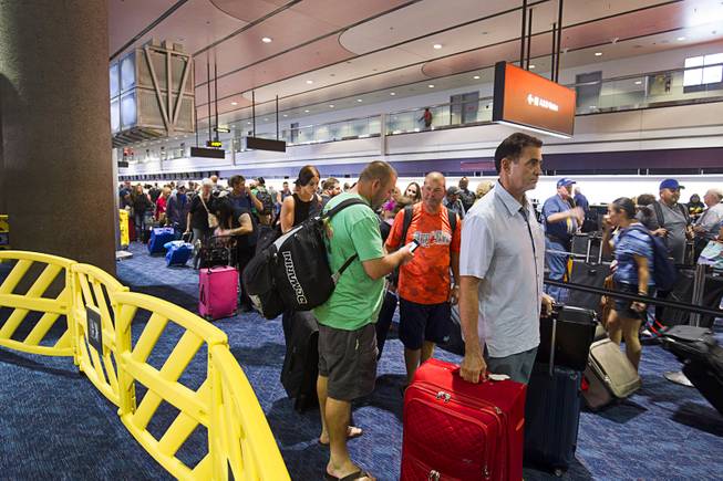 Departing Southwest Airlines passengers wait in long lines at McCarran International Airport Sunday Oct. 11, 2015. The long lines were the result of a technical issue that affected the airline's online and airport customer support services, Southwest said in a news release.