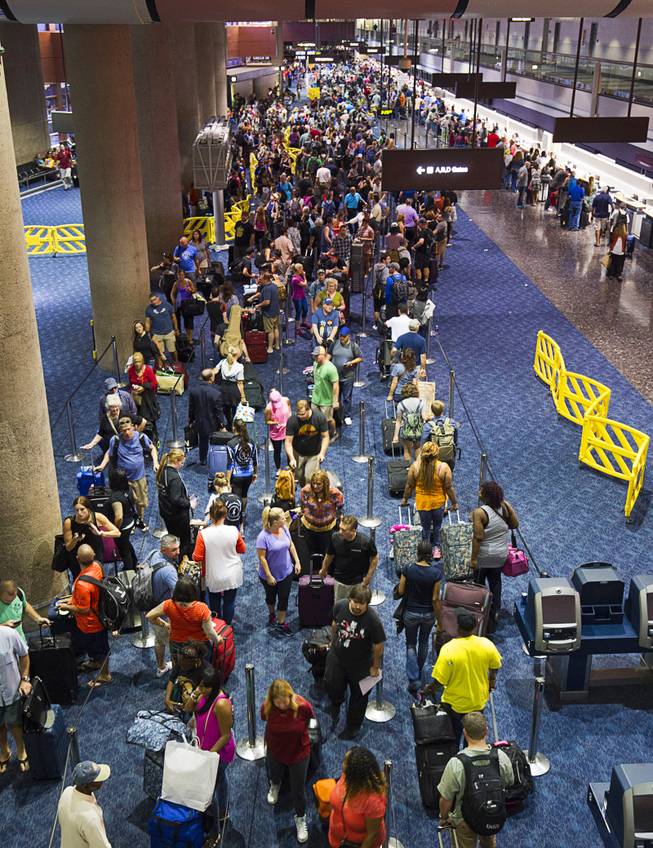 Departing Southwest Airlines passengers wait in long lines at McCarran International Airport Sunday Oct. 11, 2015. The long lines were the result of a technical issue that affected the airline's online and airport customer support services, Southwest said in a news release.