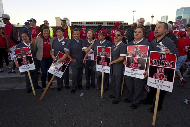 Trump Hotel workers pose for a photo with Democratic congressional candidate Lucy Flores (2nd left) during a Culinary Workers Union, Local 226, demonstration by the Trump International Hotel Monday, Oct. 12, 2015.