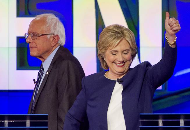Democratic presidential candidate Hillary Clinton gives a thumbs up as Bernie Sanders walks away at the end of  the CNN Democratic Presidential Debate at the Wynn Las Vegas Tuesday, Oct. 13, 2015.