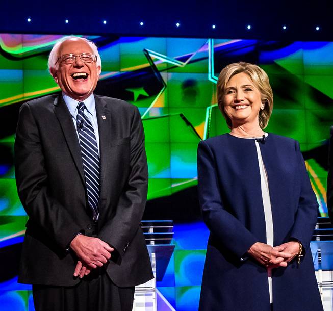 Democratic presidential candidates Sen. Bernie Sanders of Vermont and former Secretary of State Hillary Rodham Clinton share a laugh Tuesday, Oct. 13, 2015, during the CNN Democratic presidential debate at Wynn Las Vegas.