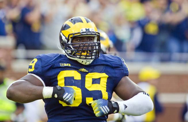 Michigan defensive tackle Willie Henry (69) celebrates after scoring a touchdown after intercepting a Utah pass in the second quarter of an NCAA college football game in Ann Arbor, Mich., Saturday, Sept. 20, 2014.