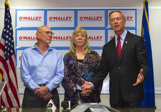 Democratic presidential candidate Martin OMalley, right, former governor of Maryland, speaks by Lonnie and Sandy Phillips, parents of shooting victim Jessica Ghawi, during a news conference at the College of Southern Nevada, Charleston Campus, Wednesday, Oct. 14, 2015. Ghawi was one of the victims in the 2012 Aurora, Colorado theater shooting.