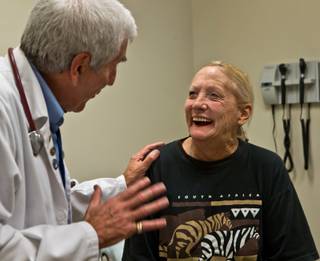 Dr. Robert Shiroff jokes with patient Kelly Bain during an appointment Wednesday, Oct. 14, 2015, at the Ruffin Family Clinic, a free clinic operated by Volunteers in Medicine of Southern Nevada that recently opened.