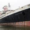 In this Nov. 22, 2013, file photo, the SS United States sits moored in Philadelphia. The historic luxury vessel that hosted princes and presidents could be sold for scrap unless a preservation group raises enough money by the end of the October. 