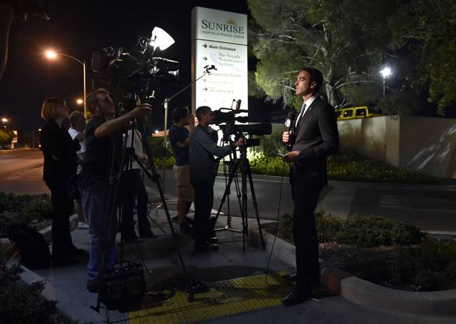 Members of the media stand outside Sunrise Hospital and Medical Center while waiting for word about Lamar Odom on Tuesday, Oct. 13, 2015, in Las Vegas. Odom, a former NBA basketball player, was hospitalized after he was found unconscious at a Nevada brothel, authorities said.