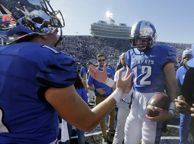 Memphis quarterback Paxton Lynch, right, celebrates with quarterback Jason Stewart after they upset No. 13 Mississippi 37-24 in an NCAA college football game Saturday, Oct. 17, 2015, in Memphis, Tenn.