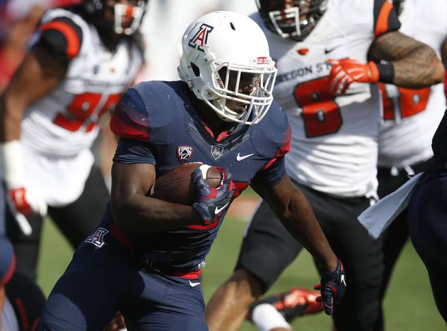 Arizona running back Nick Wilson (28) scores a touchdown against Oregon State during the first half of an NCAA college football game, Saturday, Oct. 10, 2015, in Tucson, Ariz.