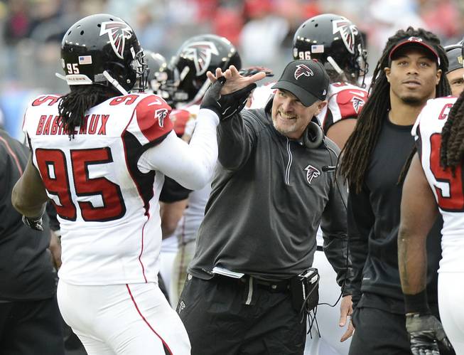 Atlanta Falcons head coach Dan Quinn, center, congratulates nose tackle Jonathan Babineaux (95) after a play against the Tennessee Titans in the second half of an NFL football game Sunday, Oct. 25, 2015, in Nashville, Tenn. (AP Photo/Mark Zaleski)